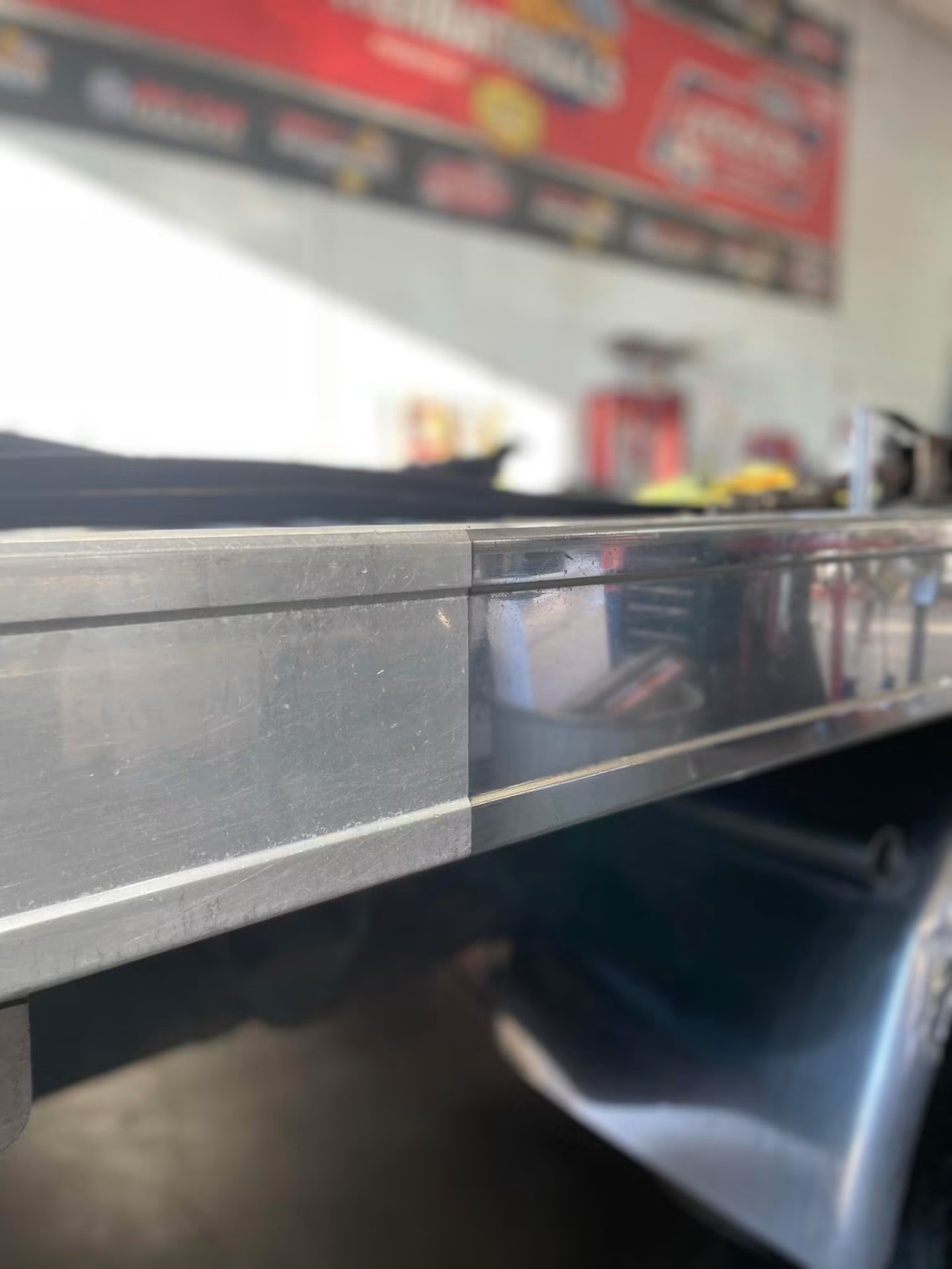 Close-up of paint correction showing a polished and unpolished surface side by side